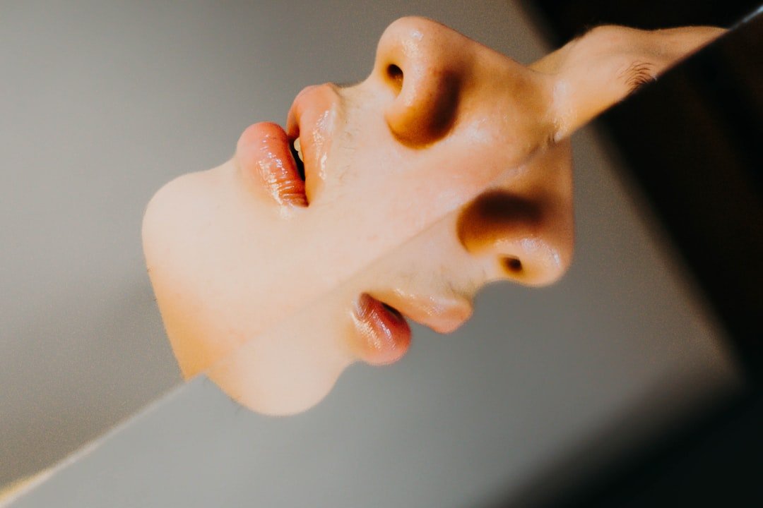 A woman's face is reflected in a mirror