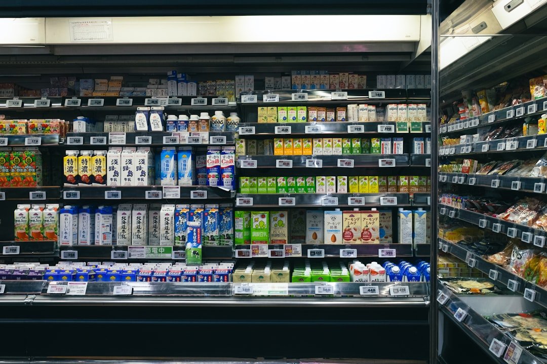 Shelves stocked with beverages and food items in a store.