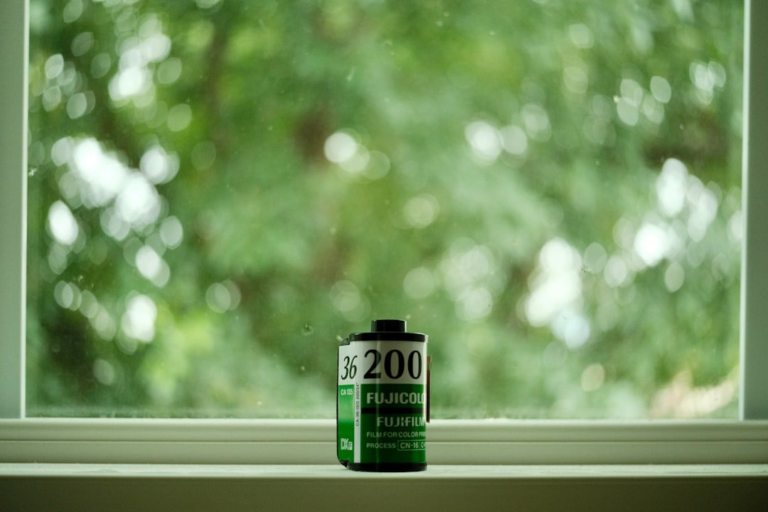 a can of alcohol sitting on a window sill