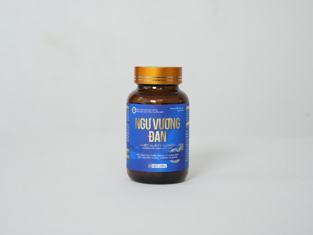 a bottle of vitamin supplement on a white background