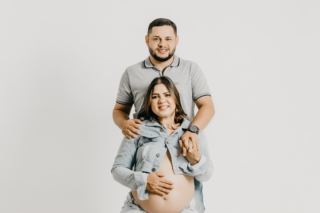 a man holding a pregnant woman in his arms
