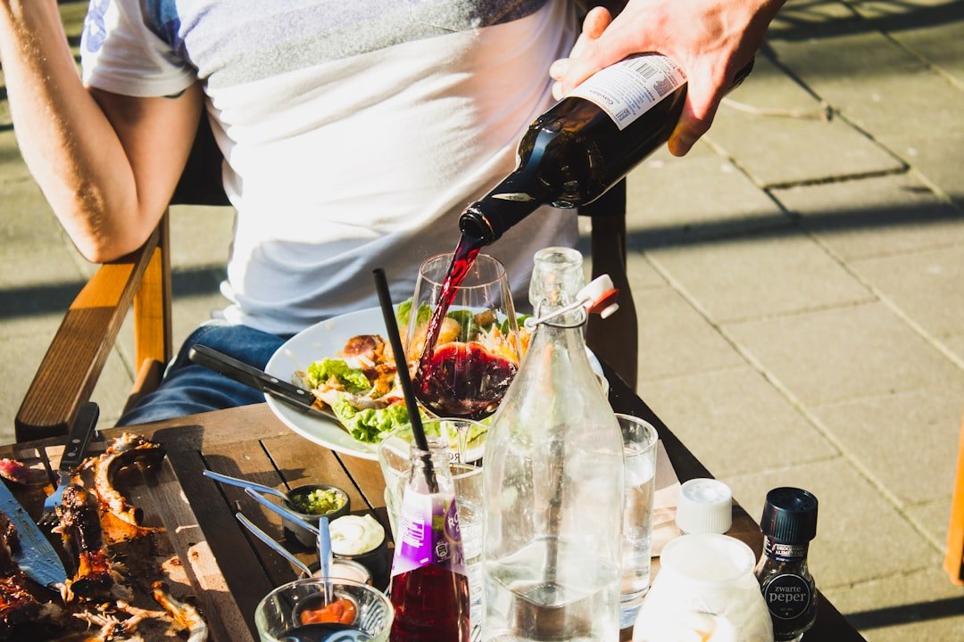 man sitting while pouring wine